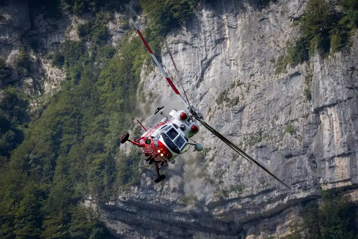 Equipo de rescate y helicóptero sobre zona de desastre asistiendo a afectados